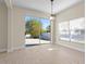 Bright room with wood-look floors, slider to the backyard, and a view of the outdoors at 7801 Belvoir Dr, Orlando, FL 32835
