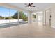 Bright living room featuring tile floors and sliding doors opening to a pool and outdoor space at 7801 Belvoir Dr, Orlando, FL 32835