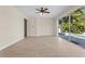 Open living room with ceiling fan and sliding glass doors that lead to a sparkling pool at 7801 Belvoir Dr, Orlando, FL 32835