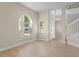 Bright living room featuring wood floors, neutral walls, and large windows for ample natural light and backyard view at 7801 Belvoir Dr, Orlando, FL 32835