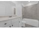 Stylish bathroom with a bathtub shower, vanity, and a large mirror at 4945 Worchester Dr, Kissimmee, FL 34746