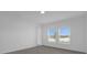 Bedroom featuring two windows and a scenic lake view at 4945 Worchester Dr, Kissimmee, FL 34746