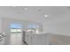 Bright open-concept living space, with tile floors, modern kitchen and dining area and a slider to a covered lanai at 4945 Worchester Dr, Kissimmee, FL 34746