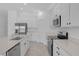 Modern kitchen with stainless steel appliances, quartz countertops, kitchen island, and white cabinets at 4945 Worchester Dr, Kissimmee, FL 34746