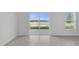 Bright living room featuring sliding glass doors with a scenic backyard view at 4945 Worchester Dr, Kissimmee, FL 34746