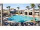 Community pool with lounge chairs, palm trees, and covered grilling and picnic area perfect for hot summer days at 4945 Worchester Dr, Kissimmee, FL 34746