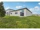 Beautiful backyard with lush green grass and a view of the home's exterior at 1390 Current Pl, Haines City, FL 33844
