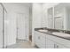 Modern dual sink bathroom with granite countertops and tiled flooring at 1390 Current Pl, Haines City, FL 33844