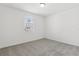 Well-lit bedroom with a large window and neutral carpet at 1390 Current Pl, Haines City, FL 33844