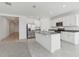 Modern kitchen featuring stainless steel appliances, white cabinets, and granite countertops with a tiled floor at 1390 Current Pl, Haines City, FL 33844