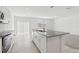 Open kitchen featuring a kitchen island with stainless steel sink and granite countertops at 1390 Current Pl, Haines City, FL 33844