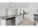 Open kitchen featuring a stainless steel dishwasher, ample countertop space and tile flooring at 1390 Current Pl, Haines City, FL 33844