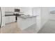 Stylish kitchen with granite countertops, stainless steel appliances, and seamless transition to a carpeted living area at 1390 Current Pl, Haines City, FL 33844