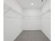 Spacious walk-in closet features ample wire shelving and neutral carpet at 1390 Current Pl, Haines City, FL 33844