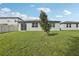 Well-maintained backyard with green grass, landscaping, privacy fence, and a view of the house at 1542 Mermaid Way, Haines City, FL 33844