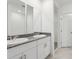 Modern bathroom with double sinks, granite countertop, and white cabinetry at 1542 Mermaid Way, Haines City, FL 33844