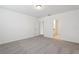 Bedroom features neutral carpet, white walls and trim, and a door leading to another room at 1542 Mermaid Way, Haines City, FL 33844