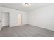 Bedroom featuring neutral carpet, white walls and trim, and a door leading to another room at 1542 Mermaid Way, Haines City, FL 33844