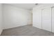 Cozy bedroom with neutral carpeting, closet, and a doorway, offering a peaceful retreat at 1542 Mermaid Way, Haines City, FL 33844