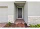 Covered front door with gray trim and stone accents, welcoming entryway at 1542 Mermaid Way, Haines City, FL 33844