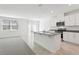 Open concept kitchen with white cabinets, gray granite countertops, and stainless steel appliances at 1542 Mermaid Way, Haines City, FL 33844
