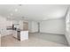 Open-concept living area with tile flooring and carpet leading into a spacious living room at 1542 Mermaid Way, Haines City, FL 33844
