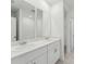 Bathroom with double sinks, white cabinets and countertop, and a bright, clean aesthetic at 3824 Giorgio Dr, Winter Haven, FL 33884