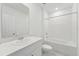A full bathroom with white countertop and cabinets, a shower and tub combination and a toilet at 3824 Giorgio Dr, Winter Haven, FL 33884