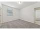 A bedroom with neutral carpeting, baseboard trim, a window with blinds and a closet at 3824 Giorgio Dr, Winter Haven, FL 33884