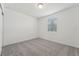 Clean, carpeted bedroom showcases a window providing natural light and a calm, neutral color palette at 3824 Giorgio Dr, Winter Haven, FL 33884