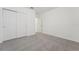 This bedroom includes neutral carpeting, baseboard trim and a closet with sliding doors at 3824 Giorgio Dr, Winter Haven, FL 33884