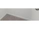 A close up on the neutral tone carpeting, baseboard trim and a ceiling light at 3824 Giorgio Dr, Winter Haven, FL 33884