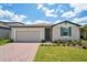 Charming single-story home featuring a brick driveway, lush lawn, and coordinated exterior paint scheme at 3824 Giorgio Dr, Winter Haven, FL 33884