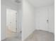 An entry hallway leads to a bathroom and living space, designed with tile and white walls at 3824 Giorgio Dr, Winter Haven, FL 33884
