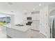 A kitchen displays a central island, stainless steel appliances and ample white cabinetry under recessed lighting at 3824 Giorgio Dr, Winter Haven, FL 33884