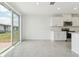 Bright kitchen space features white cabinets, stainless steel appliances, and tiled flooring at 3824 Giorgio Dr, Winter Haven, FL 33884