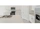Modern kitchen design showcasing stainless steel appliances and white cabinetry, complimented by a quartz countertop island at 3824 Giorgio Dr, Winter Haven, FL 33884