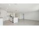 An open layout combining kitchen with stainless steel appliances and adjoining space at 3824 Giorgio Dr, Winter Haven, FL 33884