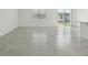 Bright living room with tiled flooring, a large window, and sliding glass doors to the backyard at 3824 Giorgio Dr, Winter Haven, FL 33884
