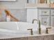 Close-up of a modern soaking tub with a sleek faucet at 708 Fox Edge Ct, Oviedo, FL 32765