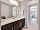 Modern bathroom with dark vanity, white quartz countertop, and a shower at 708 Fox Edge Ct, Oviedo, FL 32765