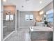Bright bathroom with a walk-in shower and a freestanding tub at 708 Fox Edge Ct, Oviedo, FL 32765