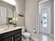 Modern bathroom with dark vanity and walk-in shower at 708 Fox Edge Ct, Oviedo, FL 32765