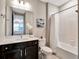 Clean bathroom with a white tub, dark vanity, and white quartz countertop at 708 Fox Edge Ct, Oviedo, FL 32765