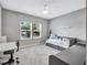 Bright bedroom with two windows, carpeted floor, and built-in storage at 708 Fox Edge Ct, Oviedo, FL 32765
