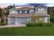 Charming two-story home featuring a well-manicured lawn and a three-car garage, perfect for Gathering living at 708 Fox Edge Ct, Oviedo, FL 32765