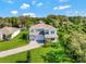 Inviting two-story home with a three-car garage, verdant landscaping, and a brick driveway at 708 Fox Edge Ct, Oviedo, FL 32765
