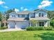 Inviting two-story home with a three-car garage and lush landscaping in a desirable neighborhood at 708 Fox Edge Ct, Oviedo, FL 32765