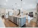 Open concept kitchen with island, stainless steel appliances, and hardwood floors at 708 Fox Edge Ct, Oviedo, FL 32765