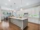 Modern kitchen with white cabinets, large island, and hardwood floors at 708 Fox Edge Ct, Oviedo, FL 32765